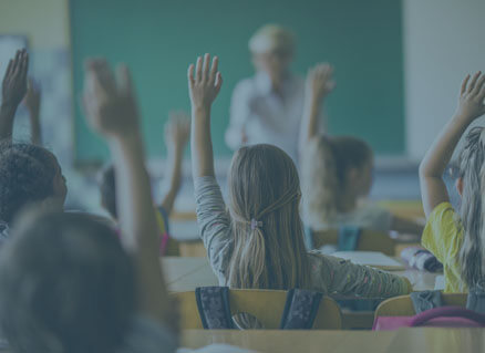 Kinder in einer Schulklasse melden sich